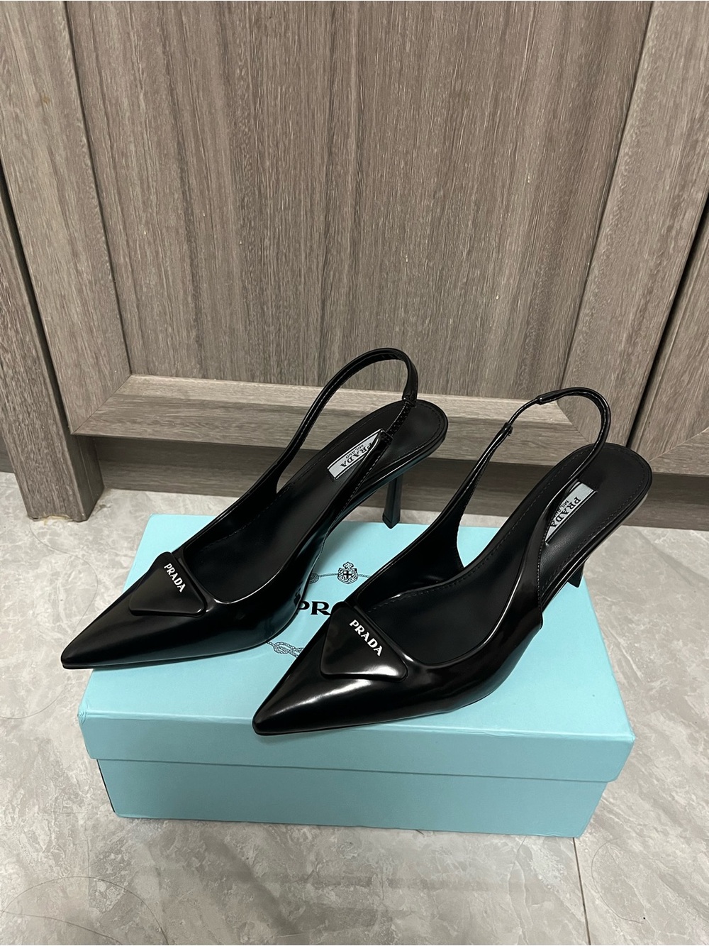 Prada Black Pointed Slingback Pumps with Logo Plaque